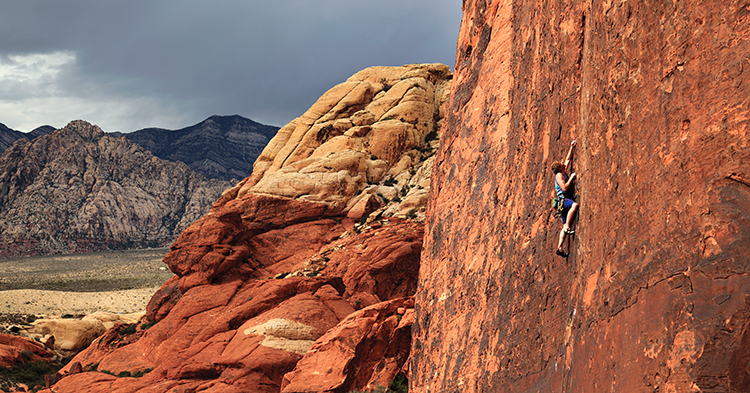 Steve Dunning on the eye-catching seam of Running Man (5.11c) before a storm chases its way into the Calico Hills. Photo: Mike Hutton